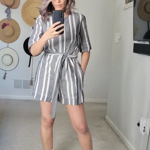 Brand new Romper with a cute bow to highlight your waist